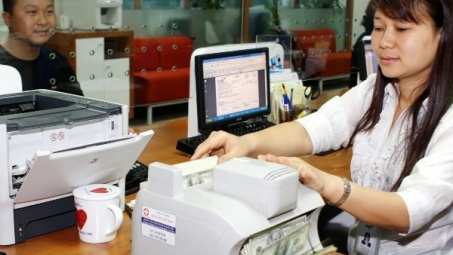 Điều chỉnh tỷ giá sẽ giảm bớt tình trạng găm giữ ngoại tệ