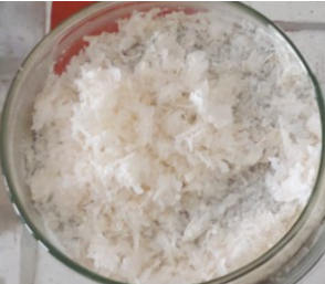 A bowl of shredded coconut

Description automatically generated